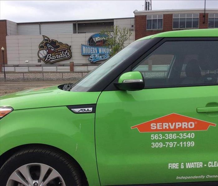 A Servpro vehicle parked in front of Modern Woodmen Park. 