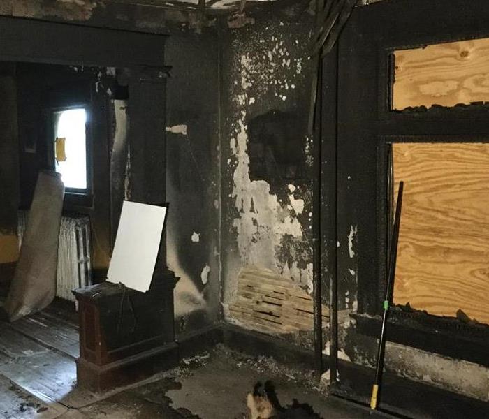 Smoke and soot damage on walls and ceiling.